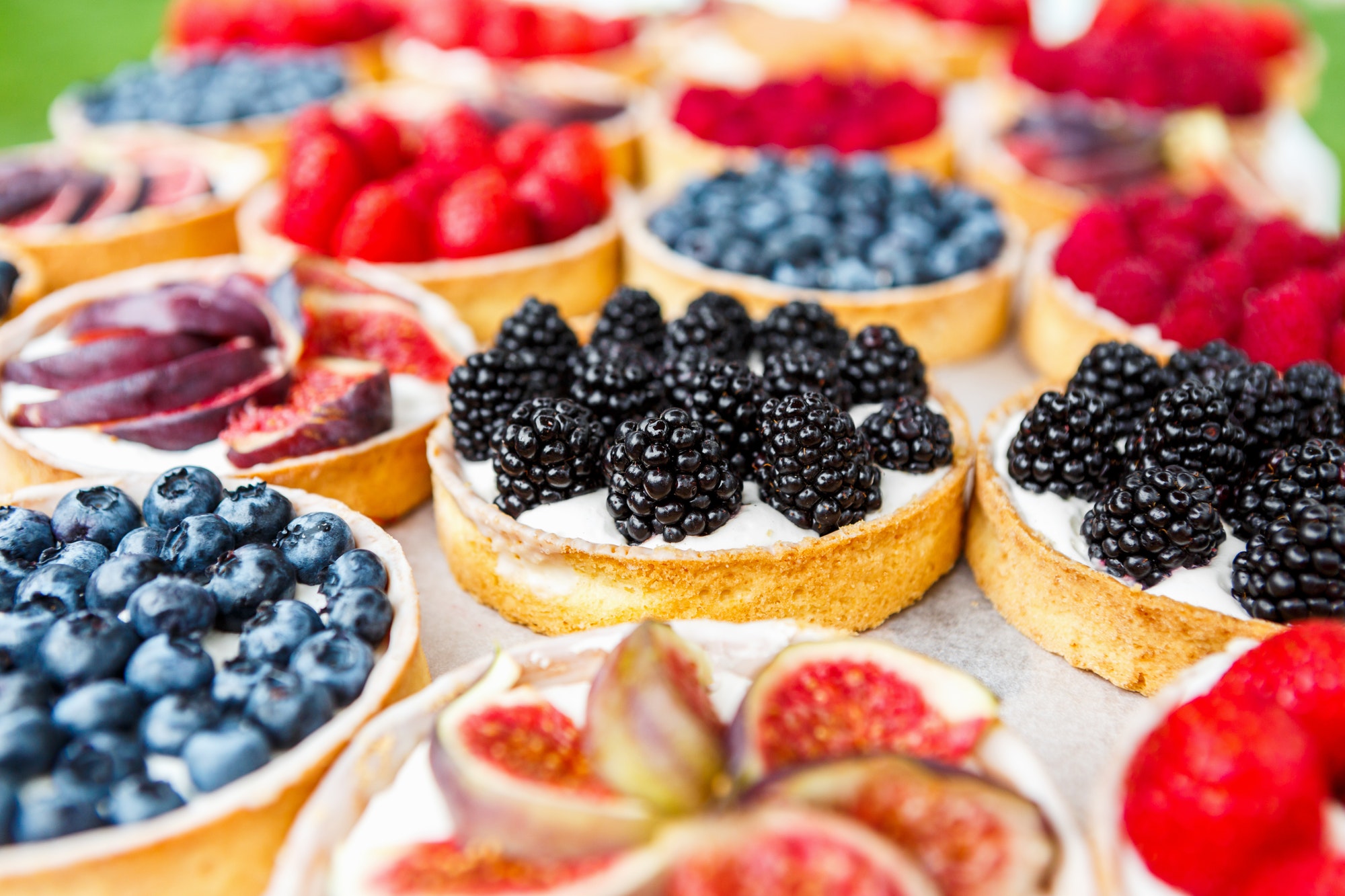 Closeup of blackberry tart dessert tray assorted